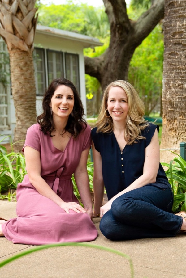 Leah and Katie sitting together outdoors.