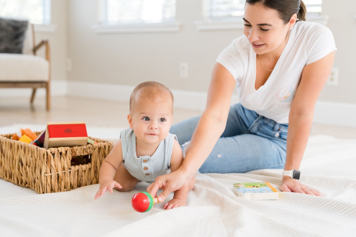 Randi engaging in floor play with a baby.